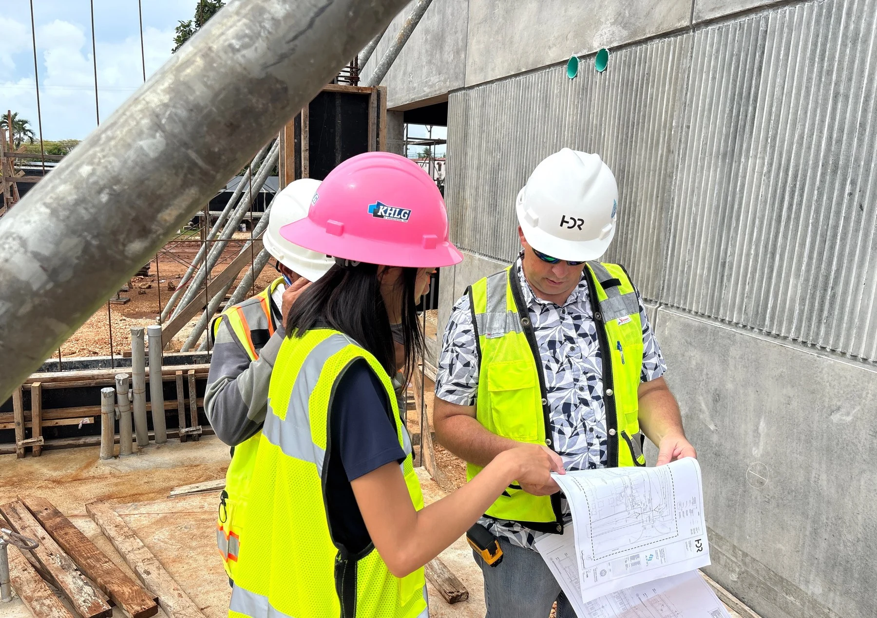 KHLG team reviewing construction plans on site